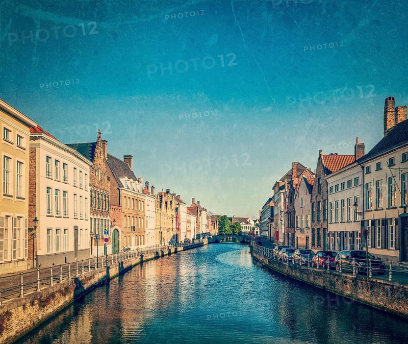 Vintage retro hipster style travel image of canal and medieval houses. Bruges