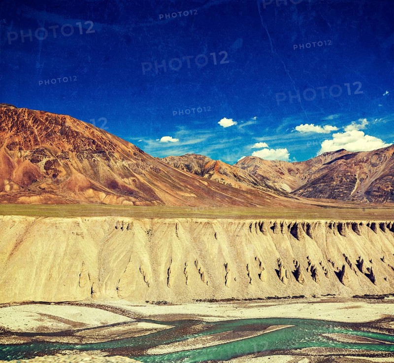 Vintage retro effect filtered hipster style travel image of Himalayan landscape in Hiamalayas near Baralacha La pass with grunge texture overlaid. Himachal Pradesh