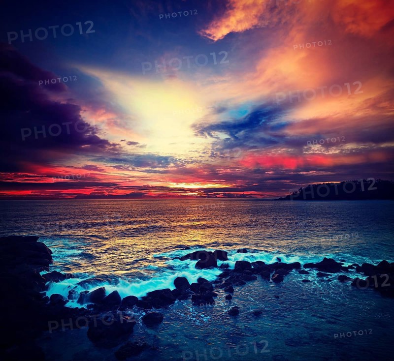 Vintage retro hipster style travel image of ocean sunset with great cloudscape