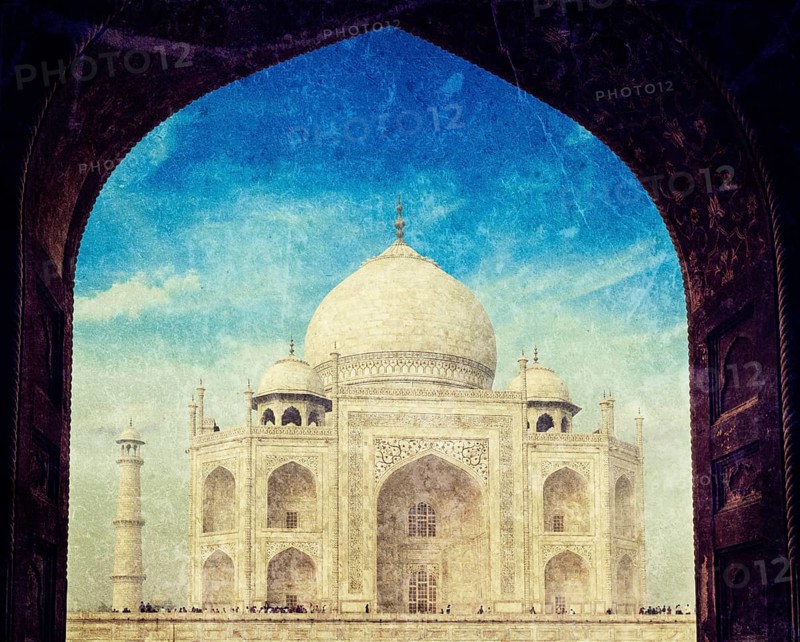 Vintage retro hipster style travel image of Taj Mahal through arch