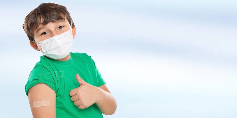 Child Boy With Plaster Inoculating Children Mask Showing Thumbs Up Against Coronavirus Corona Virus copy space Copyspace in Stuttgart