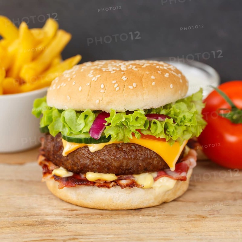 Hamburger Cheeseburger fast food meal menu with fries on wooden board square in Stuttgart