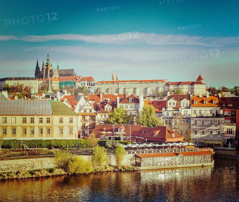 Vintage retro hipster style travel image of Mala Strana and Prague castle over Vltava river. Prague