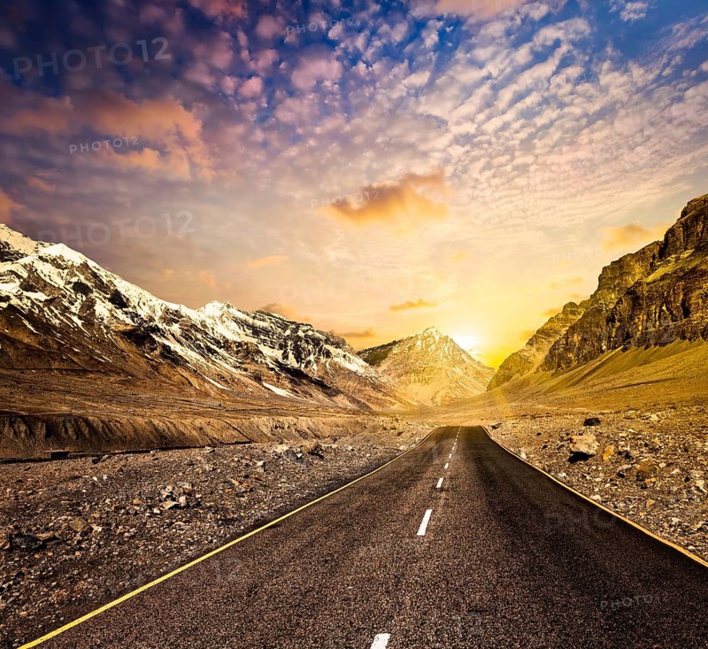 Road in Himalayas mountains on sunset