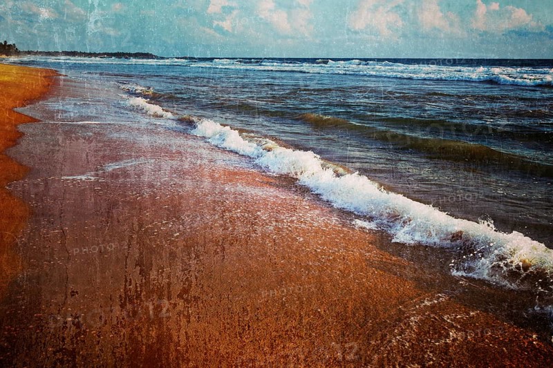 Vintage retro hipster style travel image of wave surging on sand on beach with grunge texture overlaid