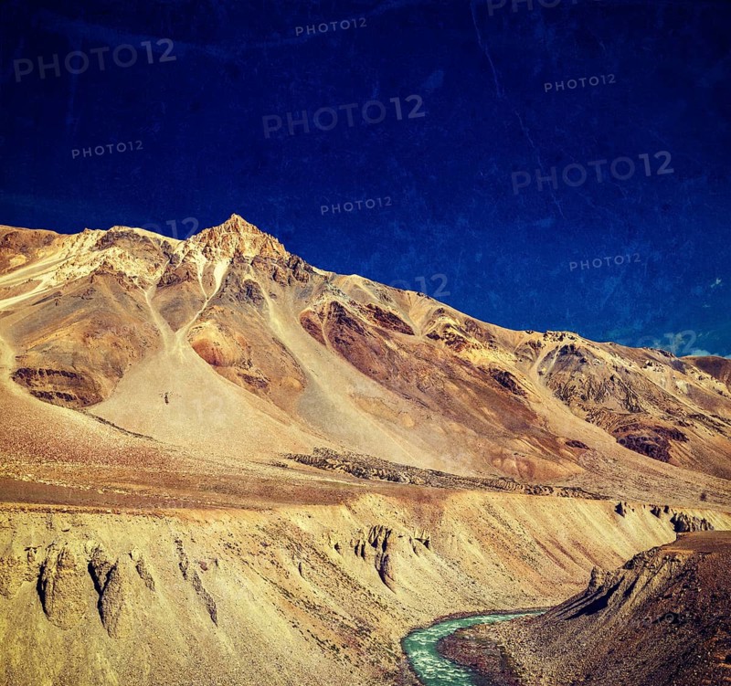 Vintage retro effect filtered hipster style travel image of Himalayan landscape in Hiamalayas near Baralacha La pass with grunge texture overlaid. Himachal Pradesh