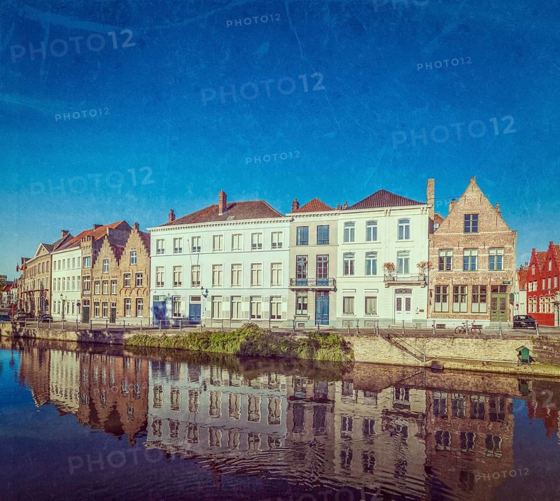 Vintage retro hipster style travel image of canal and medieval houses. Bruges