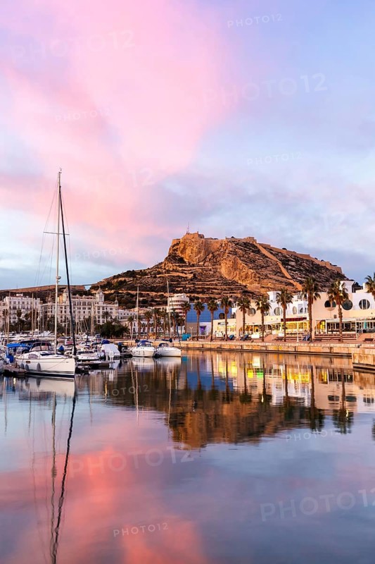 Port of Alicante in the evening Port dAlacant Marina with boats and view of Castillo Castle Holiday travel city in Alicante