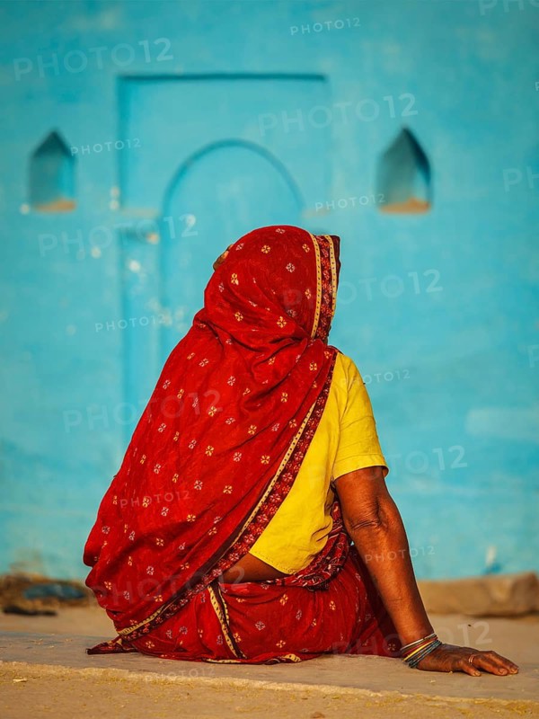 Unidentified Indian rural woman in traditional sari shot from behind