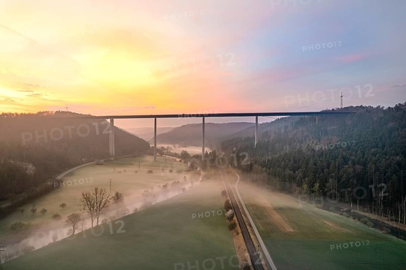 Motorway bridge with forest and fog in the sunrise