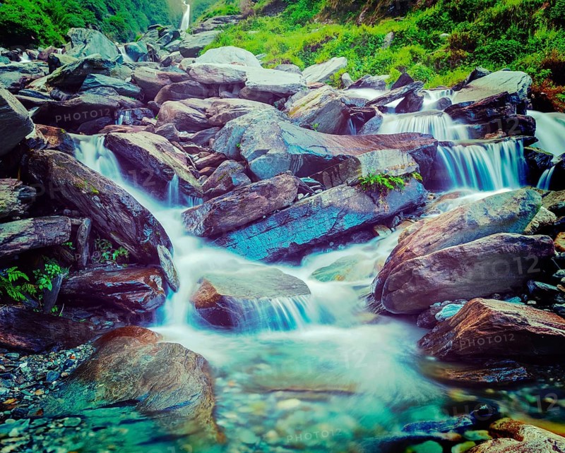 Vintage retro effect filtered hipster style travel image of cascade of Bhagsu waterfall in Himalayas. Bhagsu