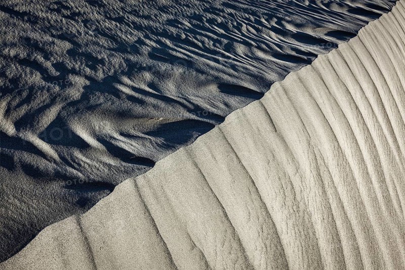 Shadow and light on Nubra Valley dunes sand close up on sunrise. Ladakh