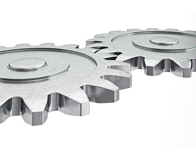 Teamwork success cooperation partnership concept: gear cogwheels working together isolated on white