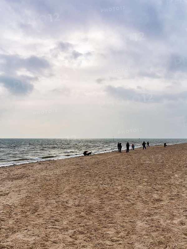 Strollers on the south beach in autumn