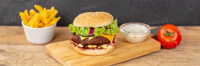 Hamburger cheeseburger fast food meal with fries on wooden board Panorama in Stuttgart