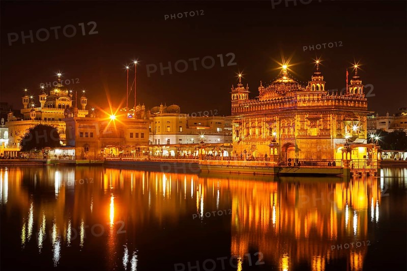 Sikh sacred site gurdwara Sri Harmandir Sahib also known as The Golden Temple also Darbar Sahib illuminated at night. Amritsar