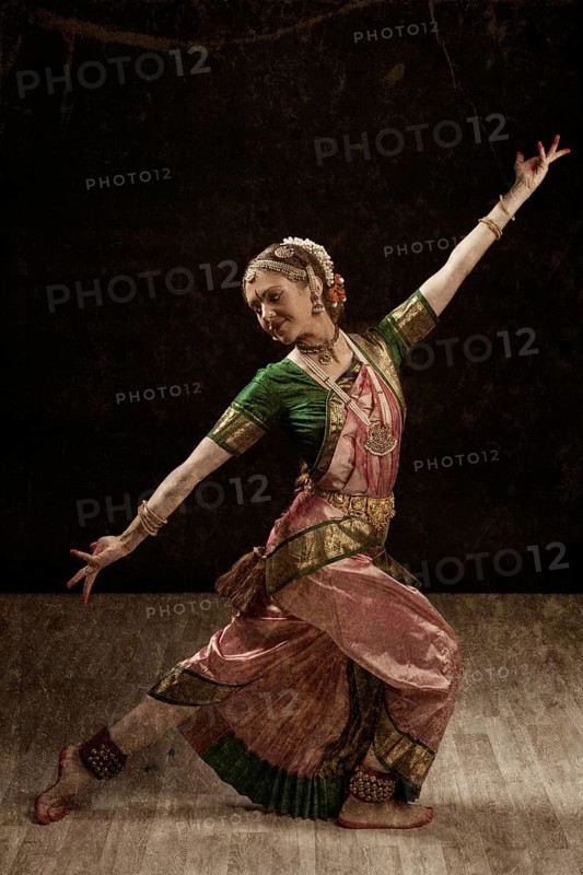 Vintage retro style image of young beautiful woman dancer exponent of Indian classical dance Bharatanatyam