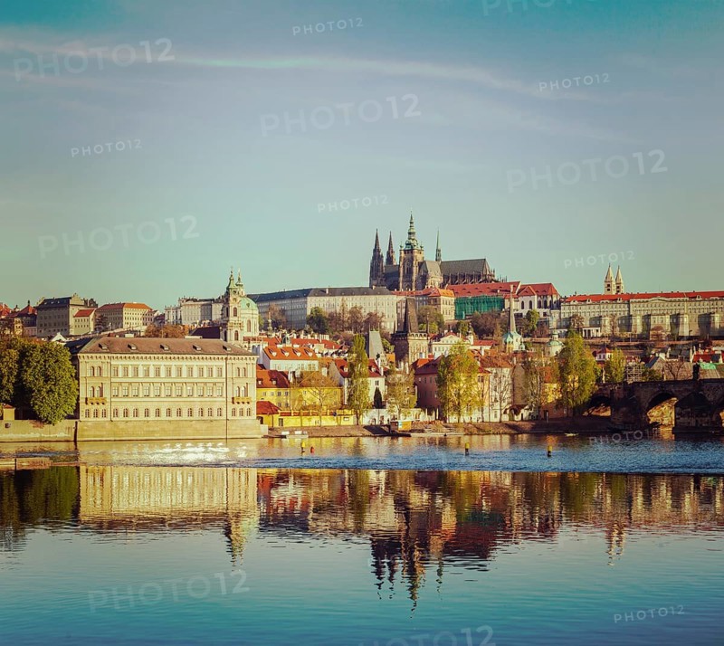 Vintage retro hipster style travel image of Mala Strana and Prague castle over Vltava river. Prague