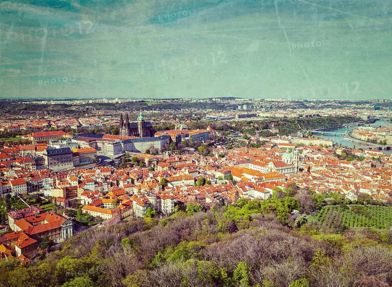 Vintage retro hipster style image of aerial view of Hradchany the Saint Vitus Cathedral and Prague Castle from Petrin Observation Tower with grunge texture overlaid. Prague