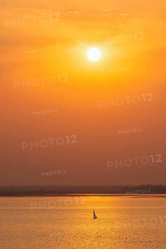 Yacht boats silhouettes in lake on sunset