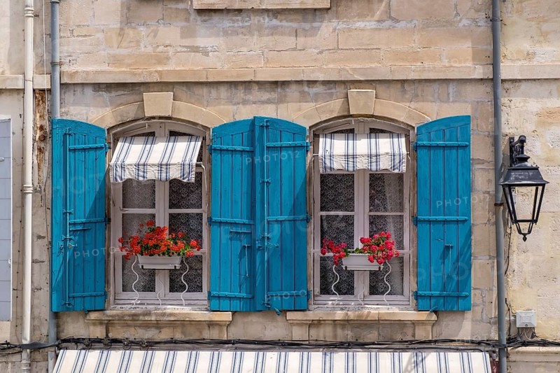 Window with blue shutters and red geraniums