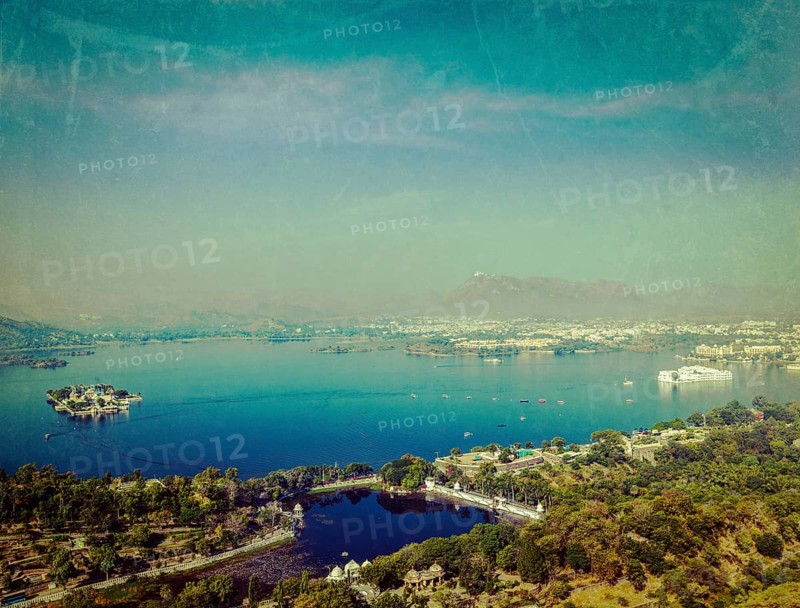 Vintage retro hipster style travel image of aerial view of Lake Pichola with Lake Palace
