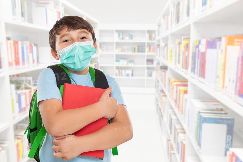 Young Pupil Child Boy at School with Mask against Corona Virus with Text Free Space Copyspace in Stuttgart
