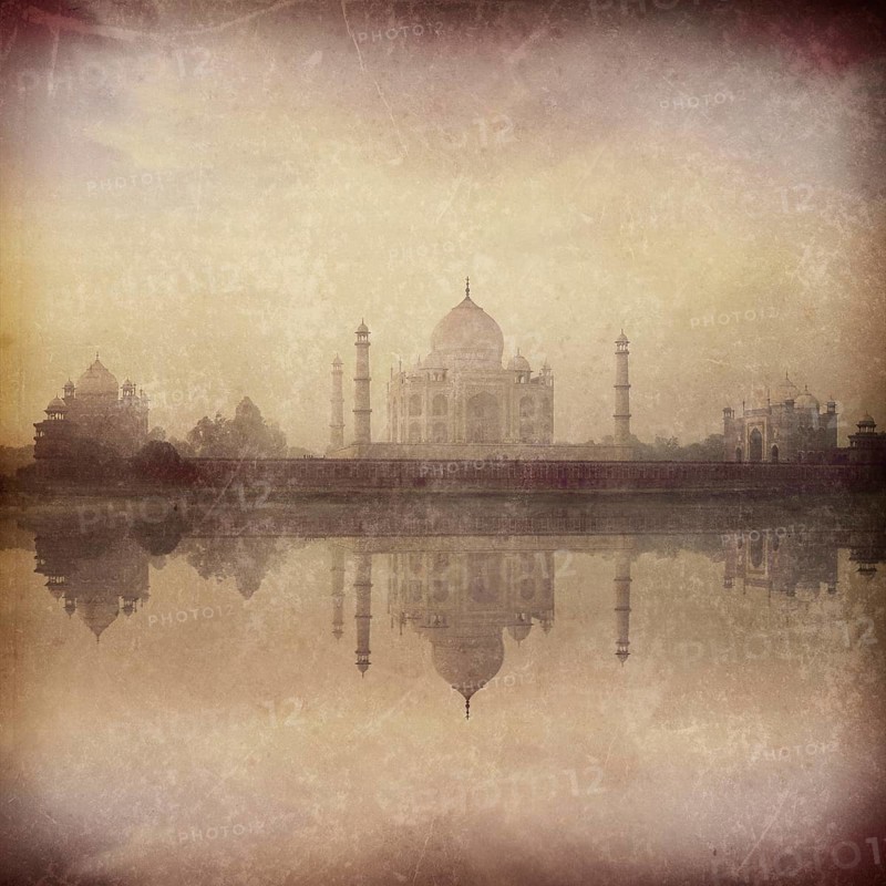 Vintage retro hipster style image of Taj Mahal on sunrise sunset reflection in Yamuna river panorama in fog