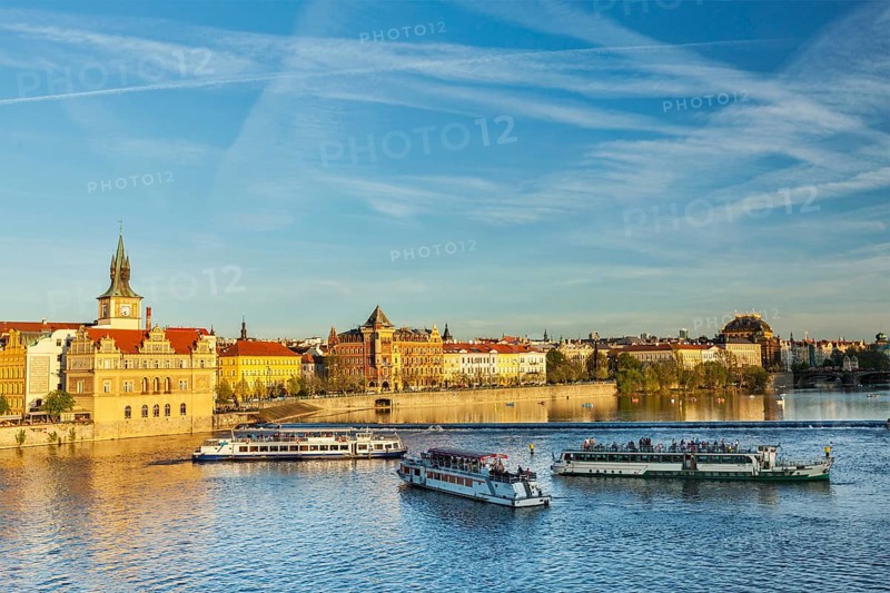 Vltava river with tourist boats and Prague Stare Mesto embankment view from Charles bridge on sunset. Prague
