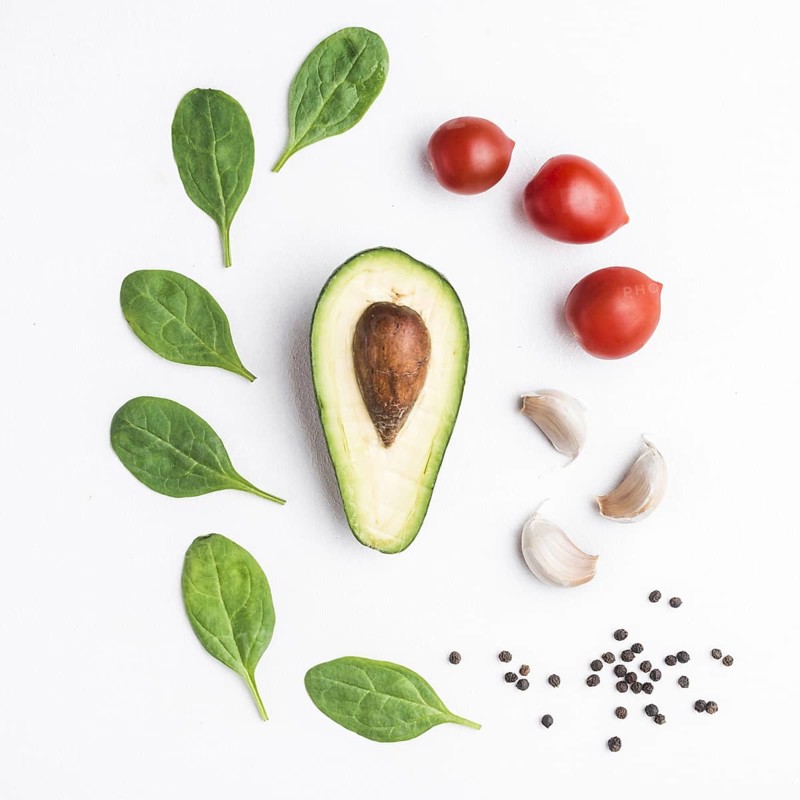 Herbs vegetables around avocado