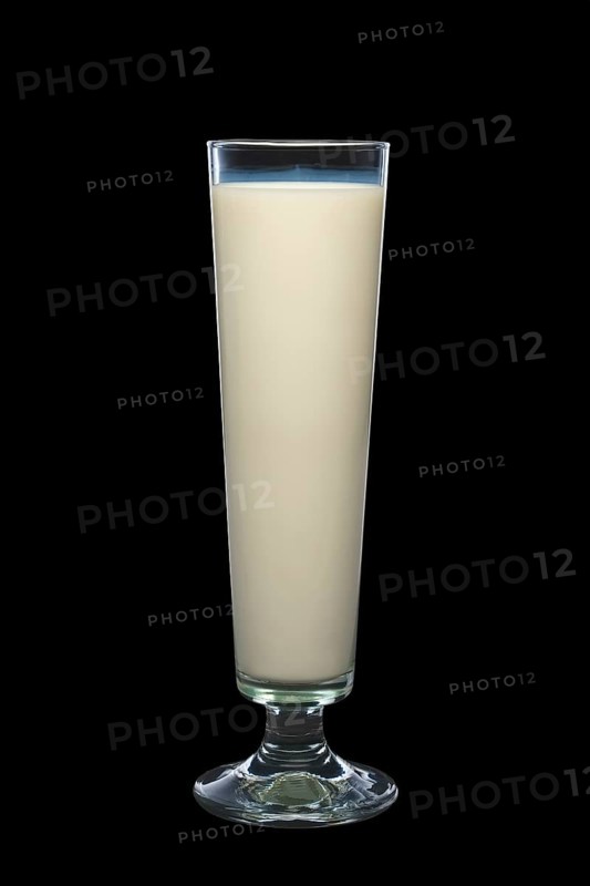 Tall glass of milk isolated on black background