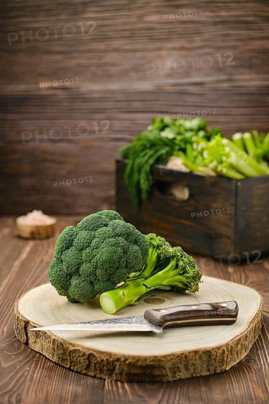 Fresh broccoli on wooden cutting board