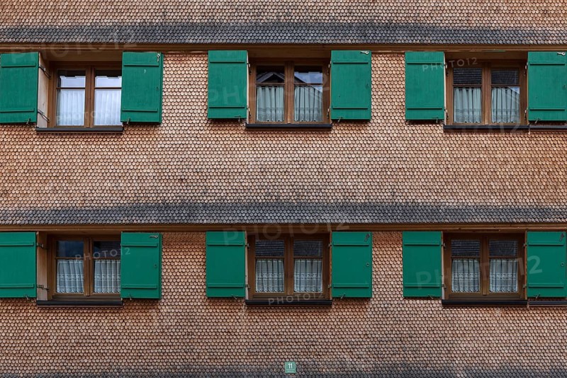 Allgaeu house with shingle facade and shutters