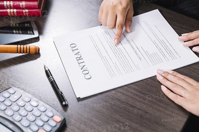 Woman pointing document near lady table with calculator smartphone pen. Resolution and high quality beautiful photo