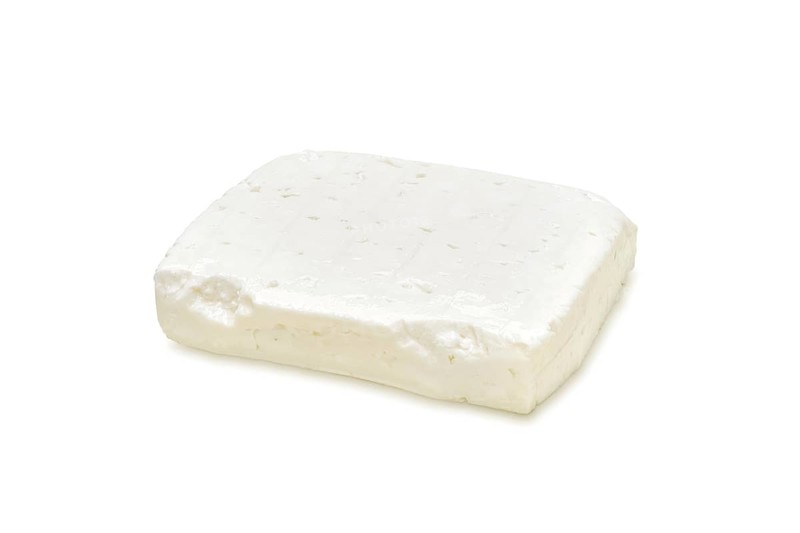 Piece of feta cheese isolated on white background