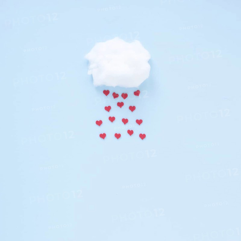Red hearts falling from cloud