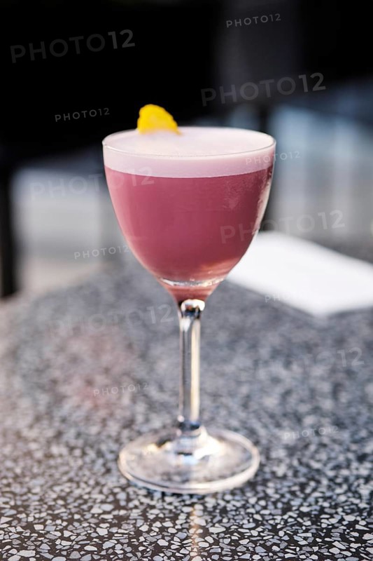 Cherry brandy cocktail on the table on outdoor terrace