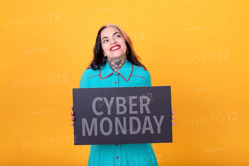Beautiful woman holding a Cyber Monday sign. Commercial concept. Commerce
