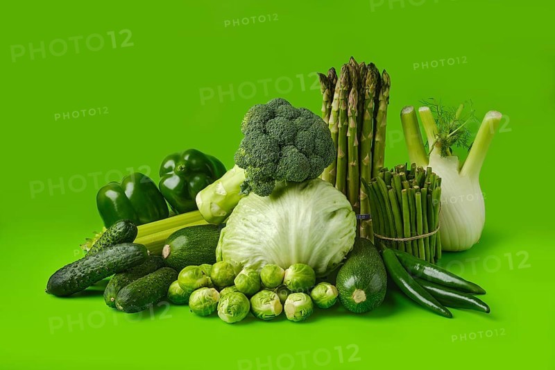 Various fresh green vegetables on wooden background