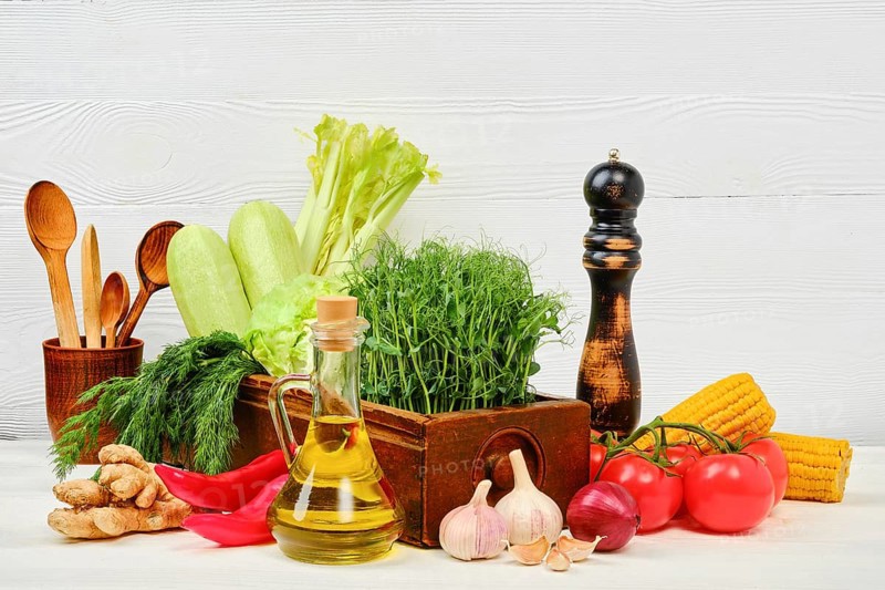 Wooden table with fresh eco vegetables and herbs. World vegan day concept with copy space for text
