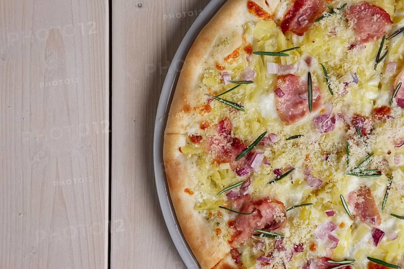 Top view of part of pizza with bacon chips