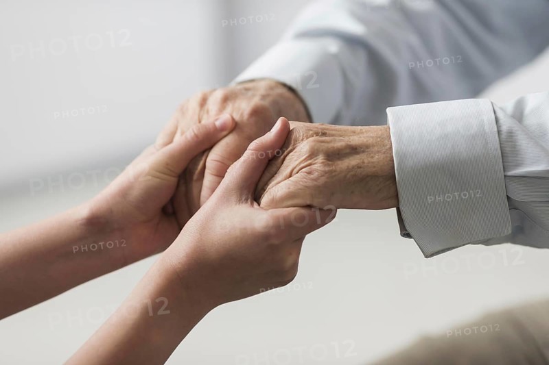 Nurse holding senior man s hands sympathy