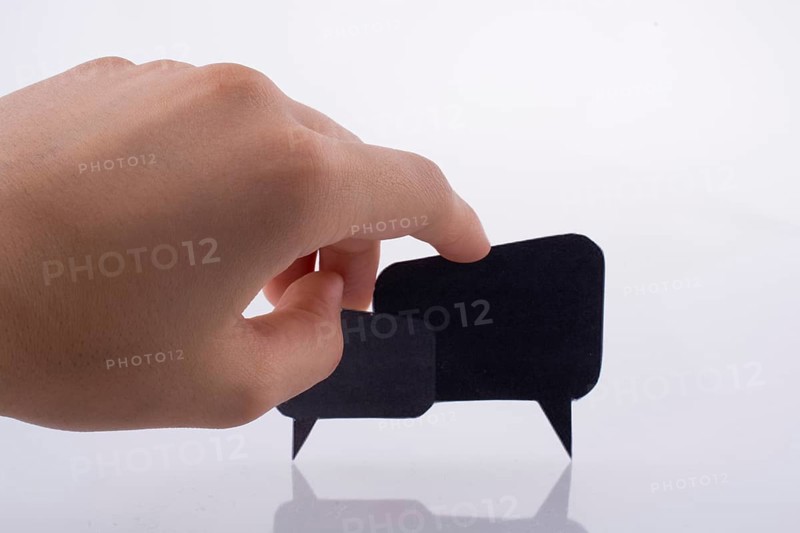 Hand holding dialogue boxes on a white background