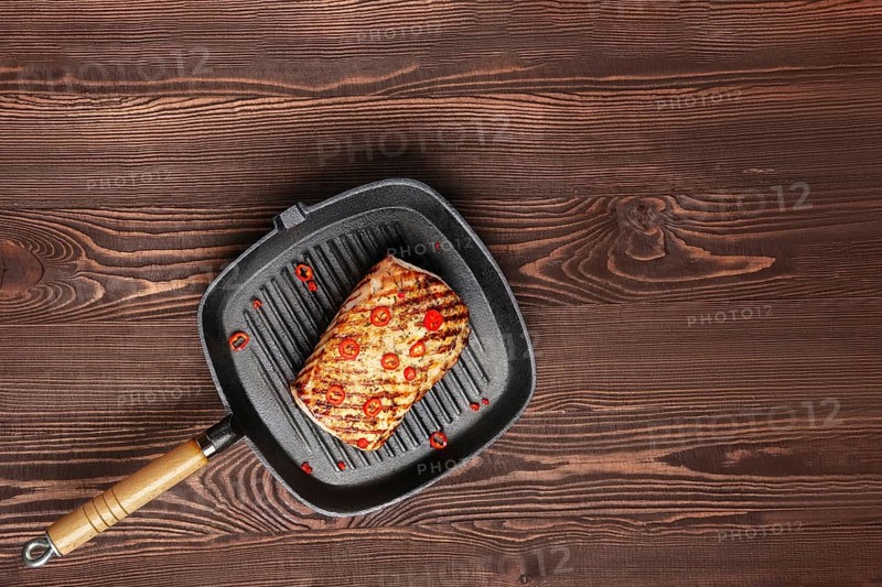 Grilled meat on cast iron skillet