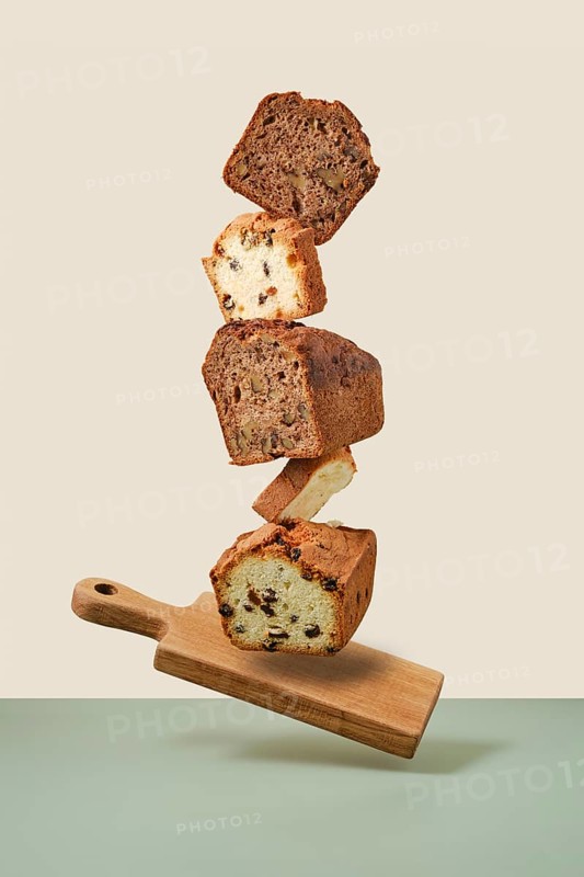 Stacked pieces of biscuit cupcakes. Balancing cakes on wooden board