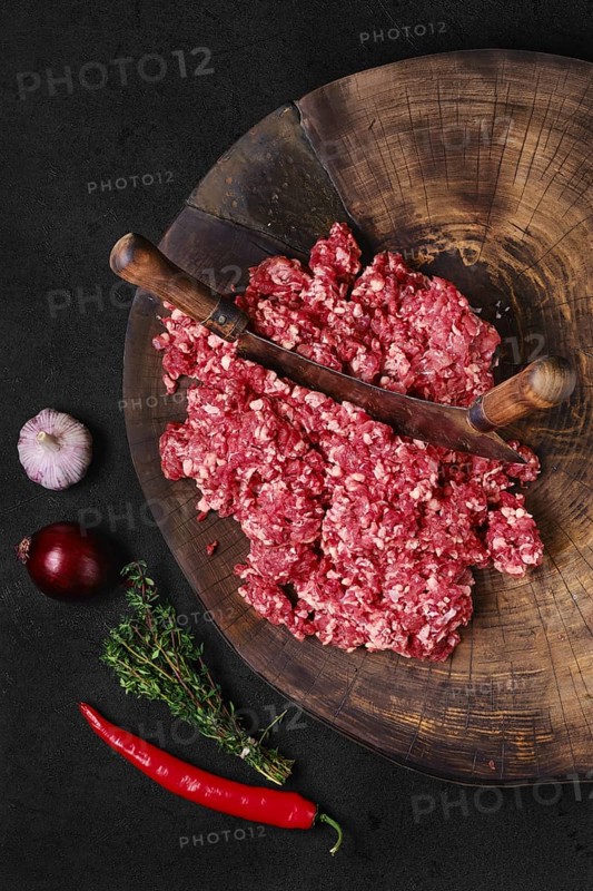 Top view of fresh beef minced meat on wooden chopping stump