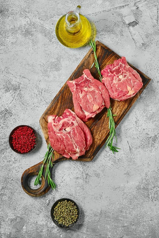 Top view of raw lamb neck meat on cutting board