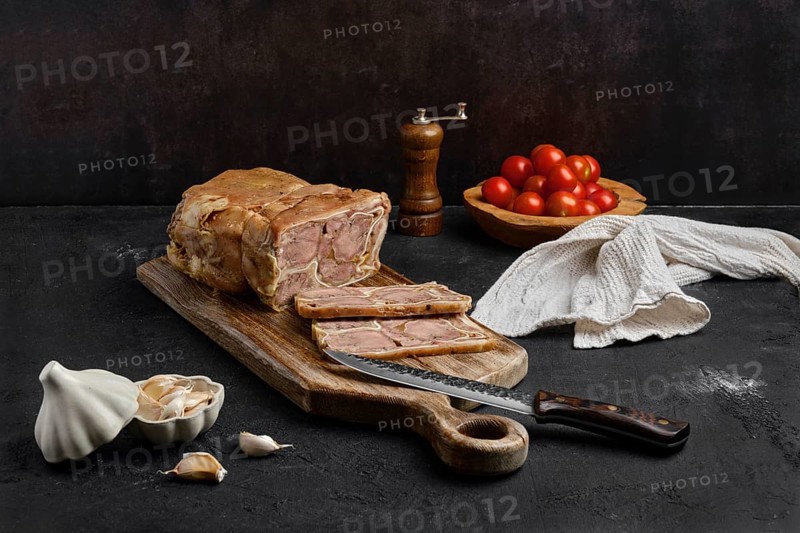 Boiled beef tongue roll on wooden cutting board