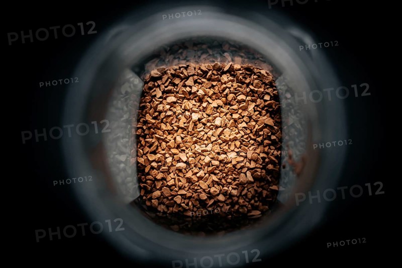 Photo of a jar with instant coffee in a dark background