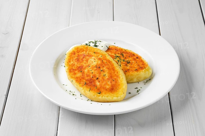 Traditional belarussian potato cakes with sour cream
